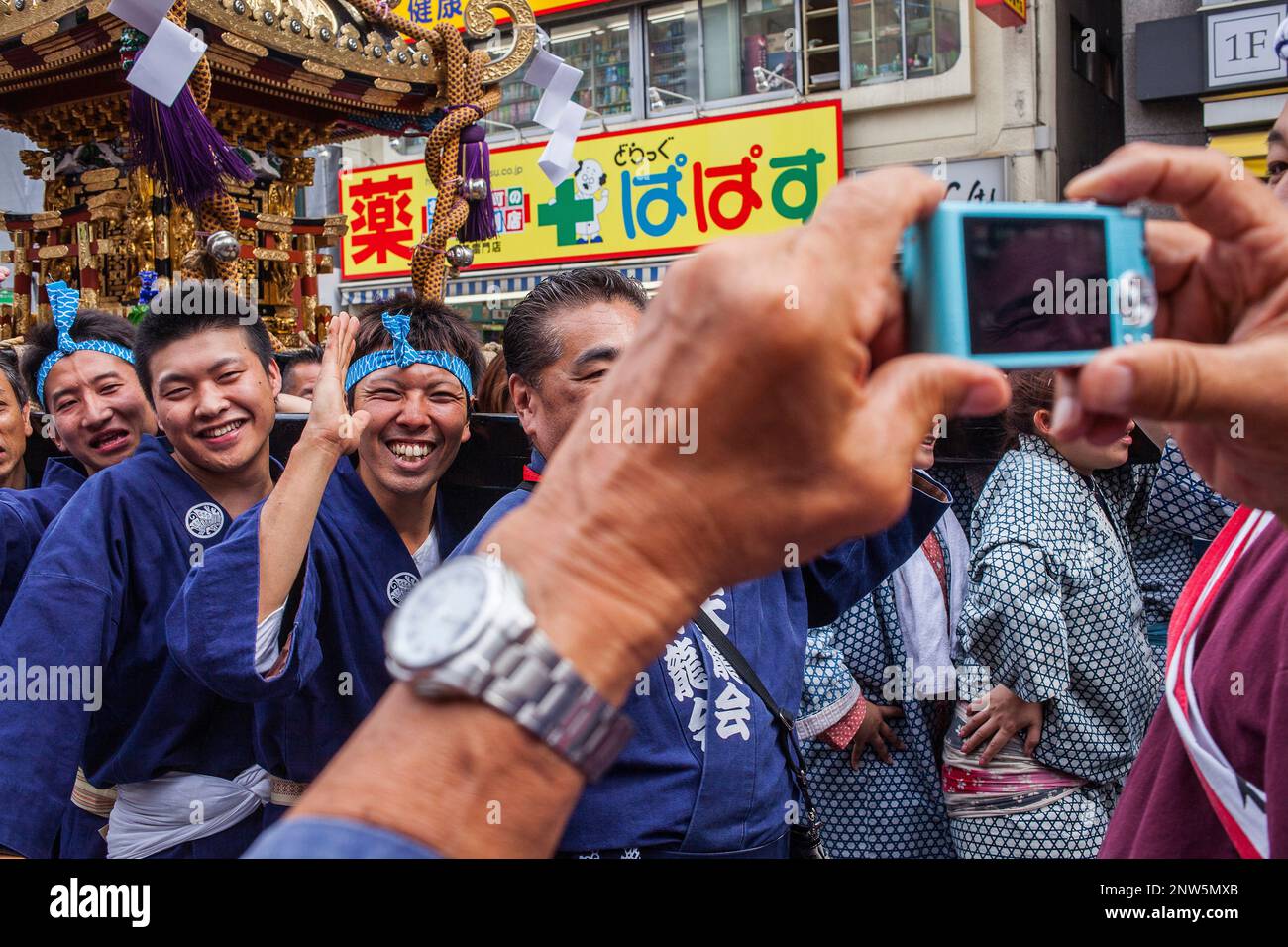 taking pictures, bearers of Mikoshi during Sanja Matsuri Festival, in Kaminarimon dori,next to Sensoji Temple, Asakusa, Tokyo, Japan, Asia Stock Photo