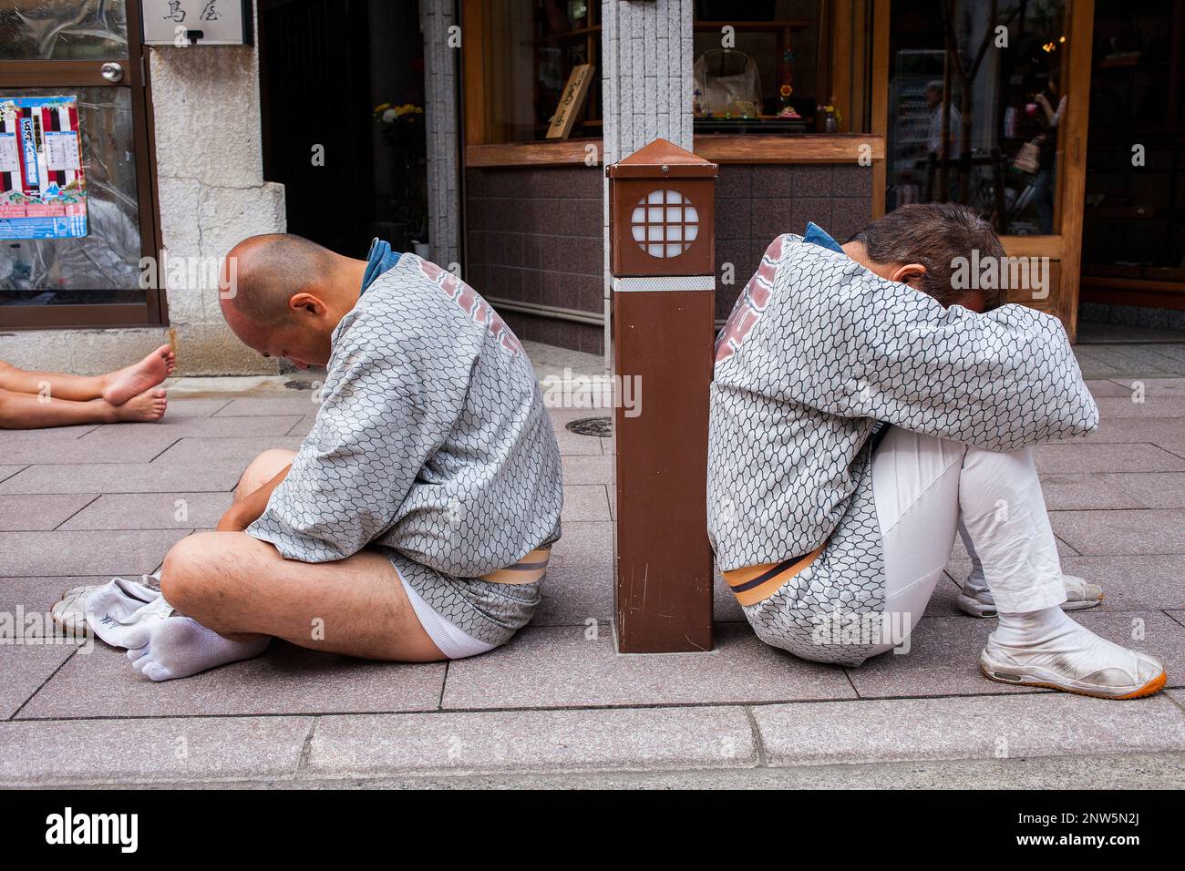 Bearers of Mikoshi resting,during Sanja Matsuri Festival in Taito city Street,next to Sensoji Temple,Asakusa, Tokyo, Japan, Asia Stock Photo