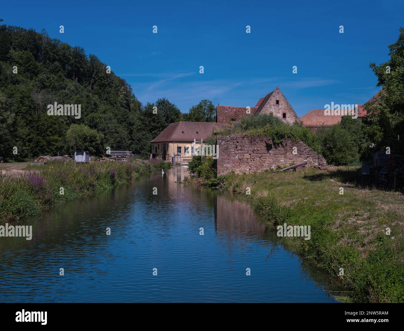 Very old water mill of the Cistercian monastery Bronnbach at the Tauber Valley Stock Photo