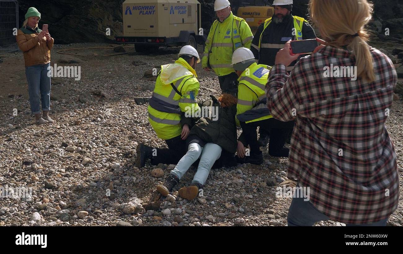 Beach protester dragged by security on Cornish beach UK Stock Photo