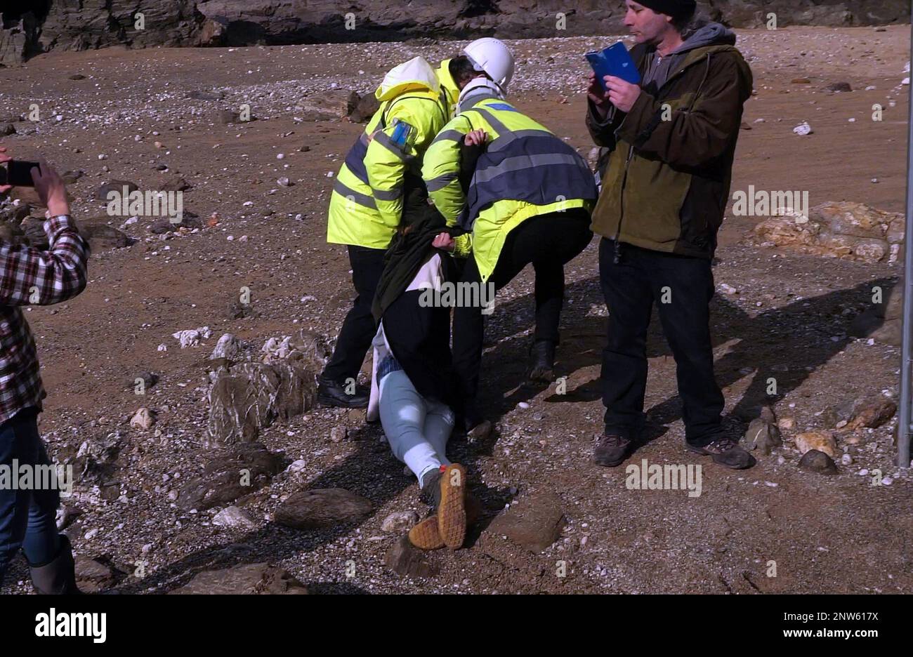 Beach protester dragged by security on Cornish beach UK Stock Photo