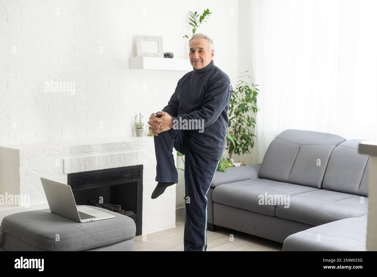 Sport in mature age. Happy middle-aged man doing stretching exercises ...