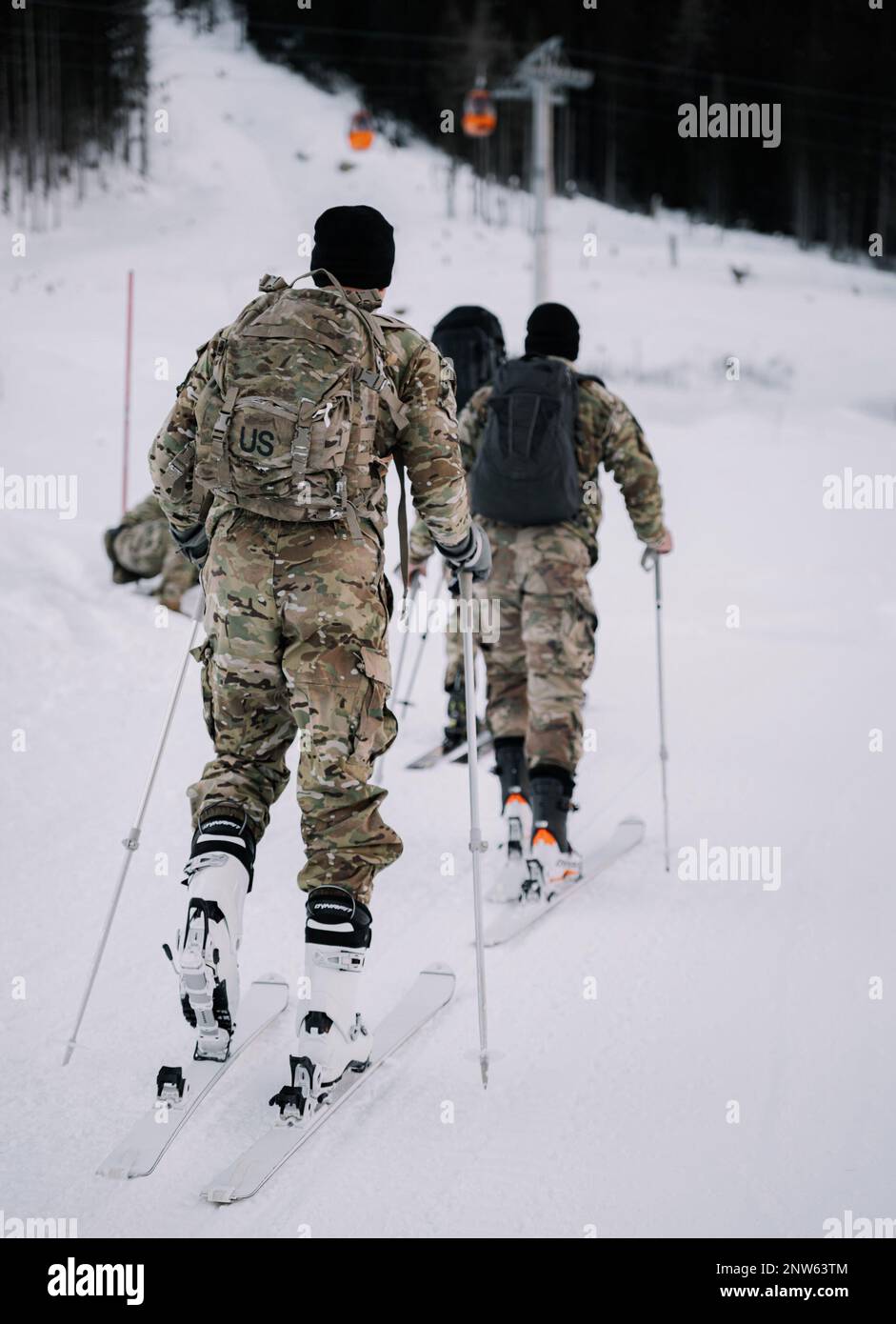 U.S. Army Paratroopers assigned to the 173rd Airborne Brigade conduct alpine ski training alongside a ski instructor from the Italian Army’s Alpini Brigade in Corvara, Italy, Feb. 1, 2023.    Exercise Alpine Star - Winter Resolve is an Italian Army-hosted multinational mountain and arctic warfare training exercise. Three reconnaissance platoons from the 173rd Airborne Brigade take part in a three-phase training regimen led by the Alpini Brigade to expand force capabilities by learning how to move, shoot and operate in mountainous and arctic conditions. Over the course of the training, these pa Stock Photo