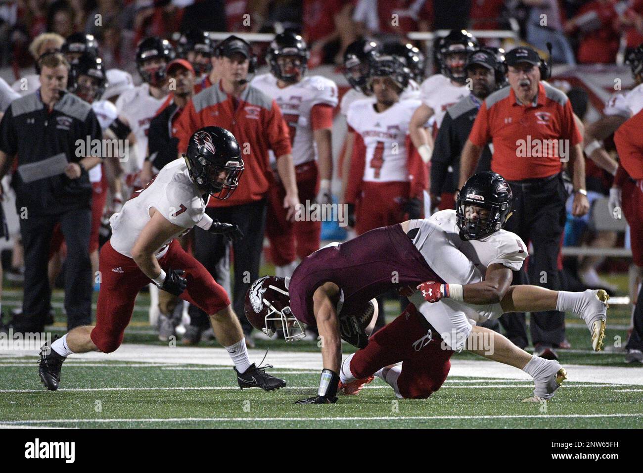 Morningside receiver Connor Niles center is tackled by