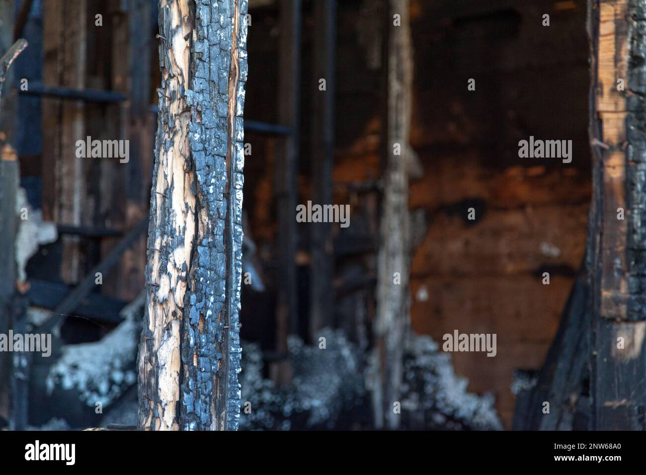 Close-up on a wooden house burnt to the ground by a pyromaniac. Stock Photo
