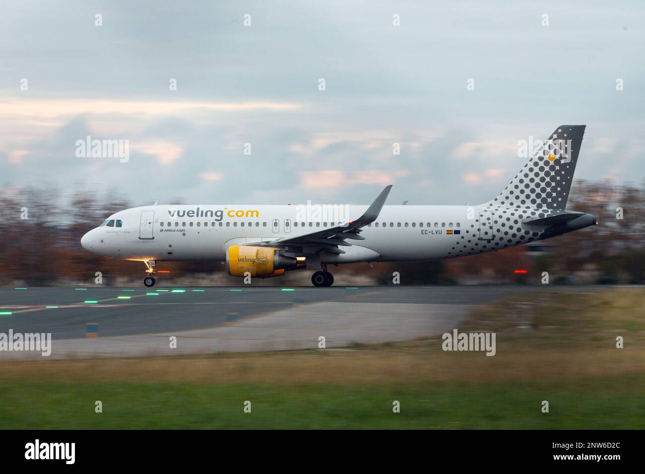 Santander, Spain - December 6, 2022: An Airbus A320 plane of the Vueling company, circulates on the runway of the Seve Ballesteros airport in Santande Stock Photo