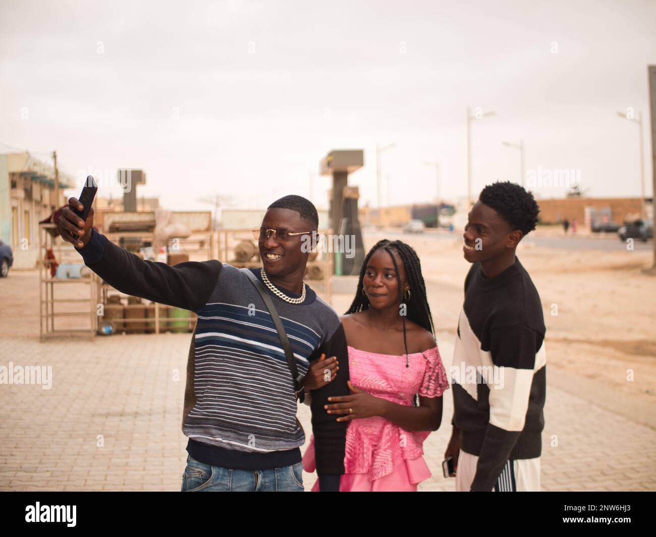 Three african friends taking a selfie in the Nouakchott city streets Stock Photo
