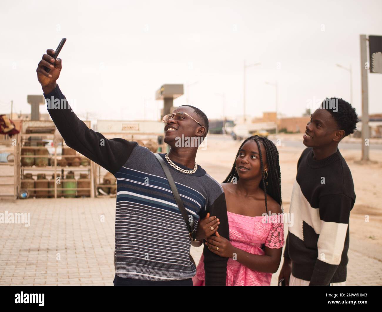 Three african friends taking a selfie in the Nouakchott city streets Stock Photo
