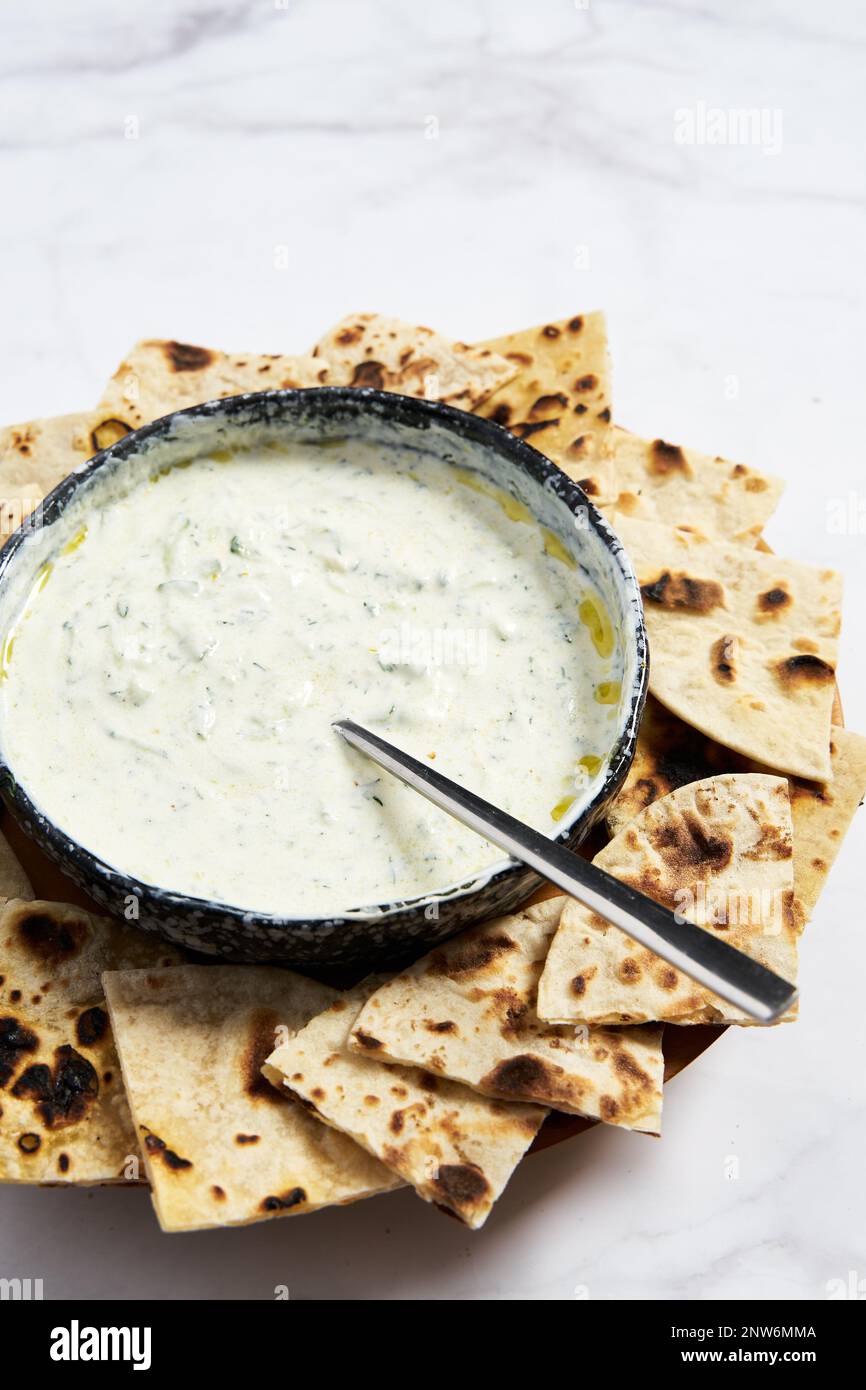Tzatziki sauce with pan roasted pita bread. Homemade greek sauce from yogurt, dill and cucumber