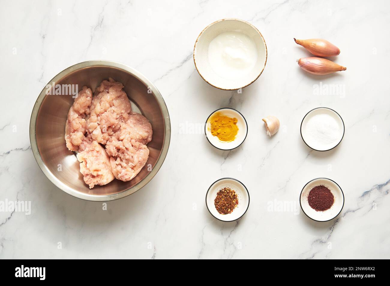 Chichen Persian Koobideh Kebab ingredients top view chicken and yogurt with turmeric, chilli
