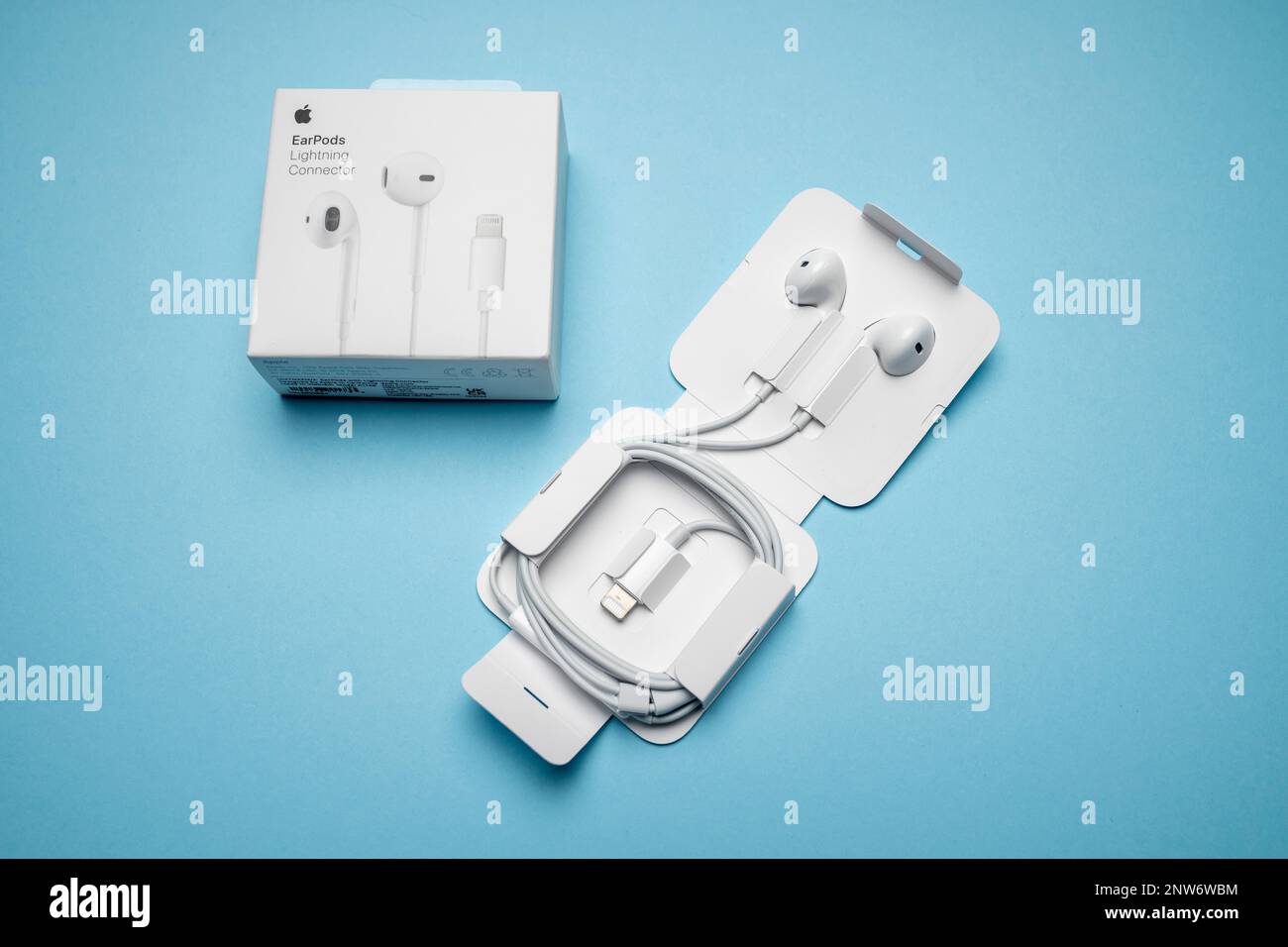 New Apple Earpods, Airpods white earphones for listening to music and  podcasts in an open box. Isolated blue background. Budapest, Hungary -  February Stock Photo - Alamy