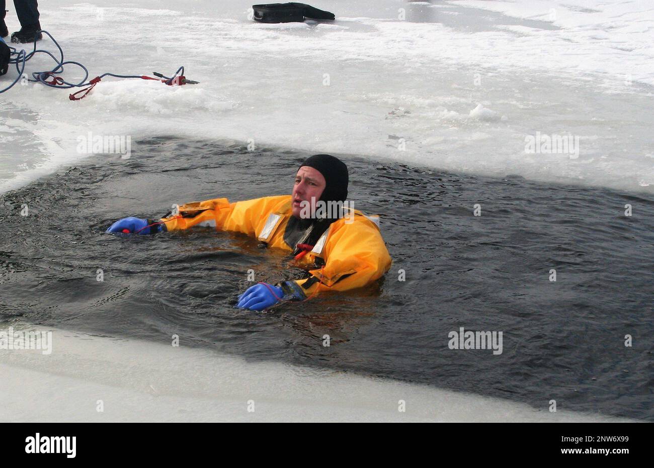 A firefighter wearing a cold-water immersion protective suit acts as a ...