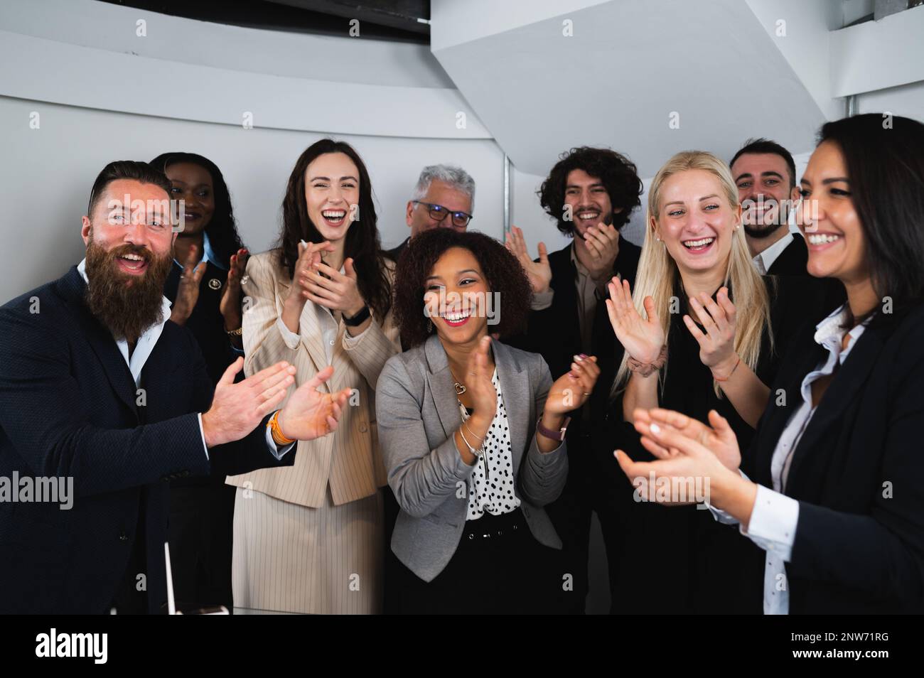 Multiracial group of businesspeople clapping hands with happy faces.congratulate for Business achievement and success concept. Stock Photo