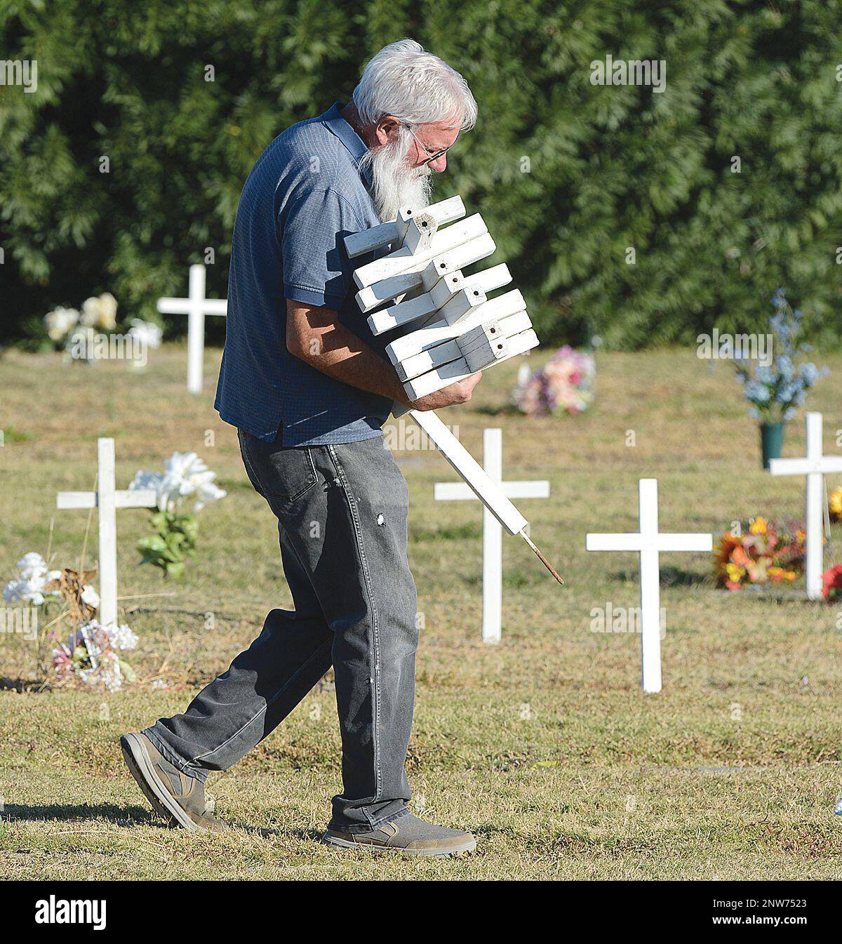 U.S. Navy veteran Lauren Heitzman carries an armload of crosses to be ...