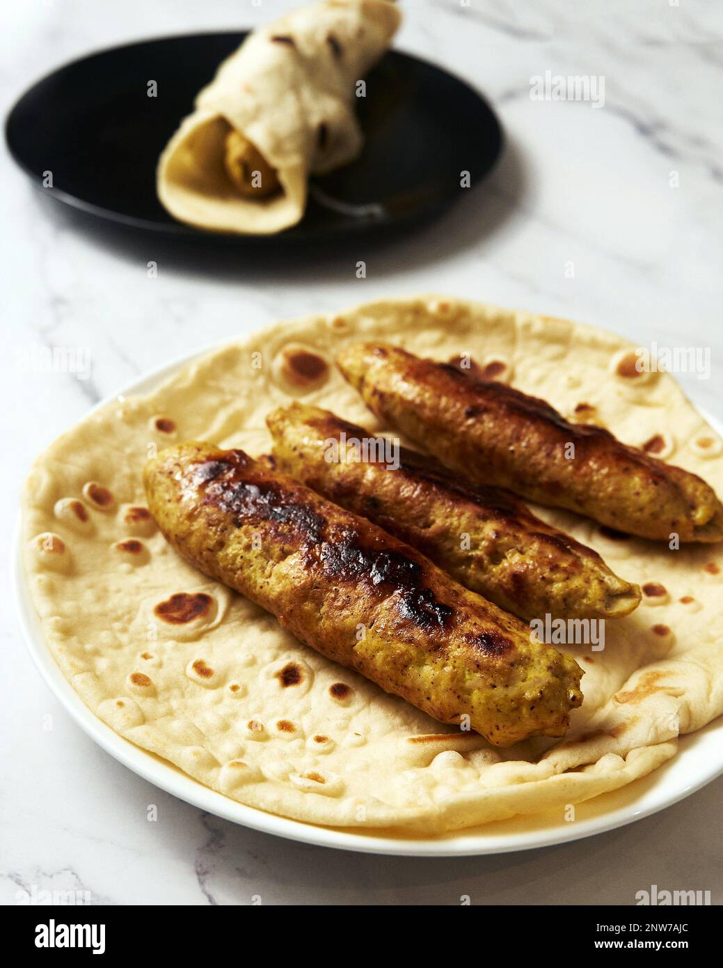 Chichen Persian Koobideh Kebab. Kebab with turmeric, onions, sumac, and other ingredients. On lavash bread Stock Photo