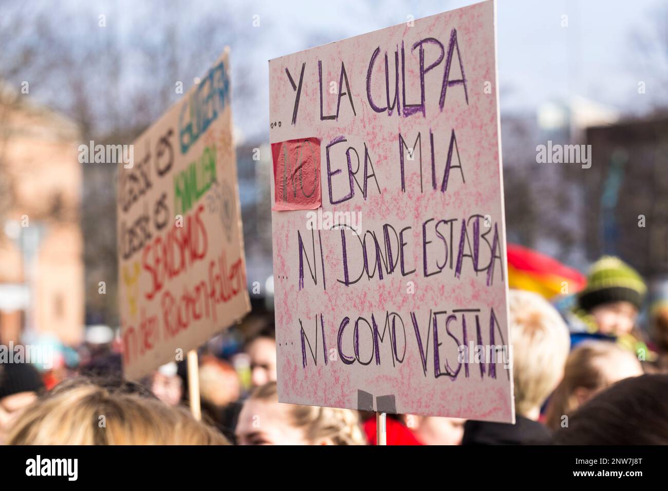 Berlin Germany 3/8/2020 International Women's Day march, makeshift protest sign in Spanish: “and it wasn't my fault where I was or how I was dressed'. Stock Photo