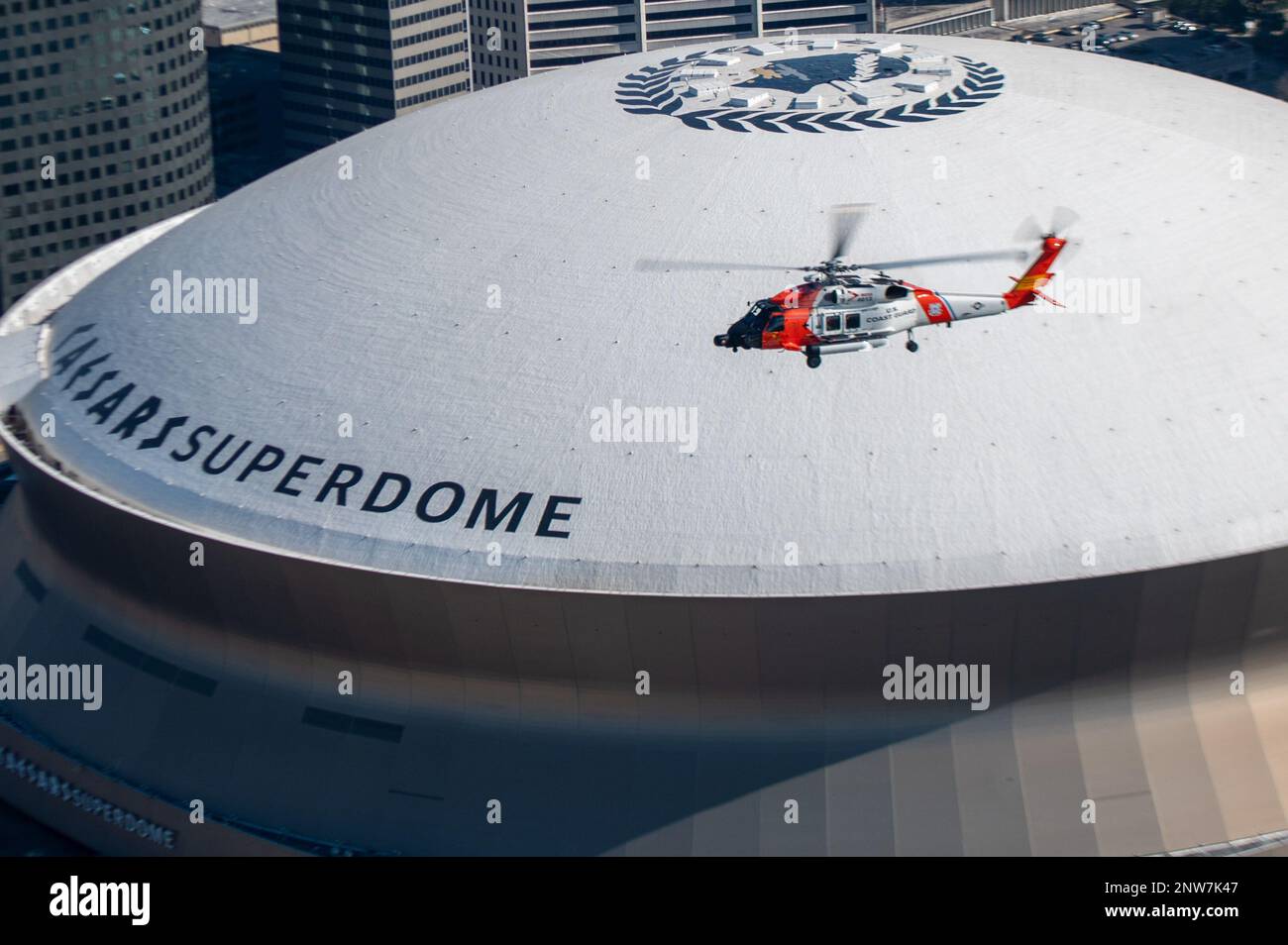 A Coast Guard Air Station New Orleans MH-60 Jayhawk aircrew flies over the Caesars Superdome in New Orleans, Louisiana on Jan. 26, 2023. Two Air Station New Orleans aircrews flew over the city before conducting emergency landing training and hoists. Stock Photo
