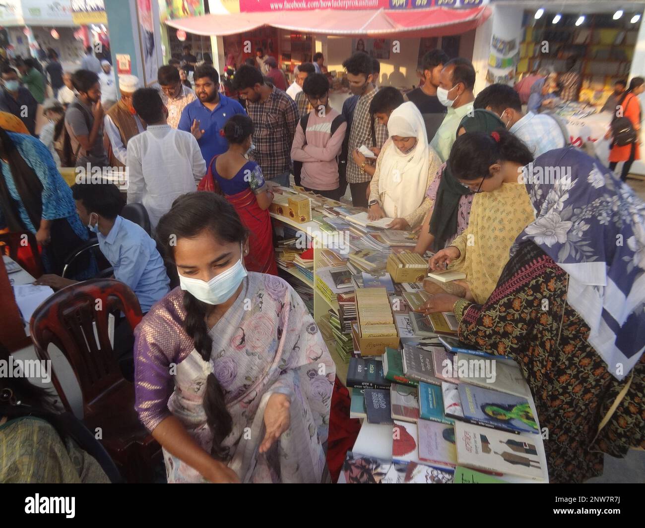Dhaka, Bangladesh. 28th Feb, 2023. People check books for purchase at a