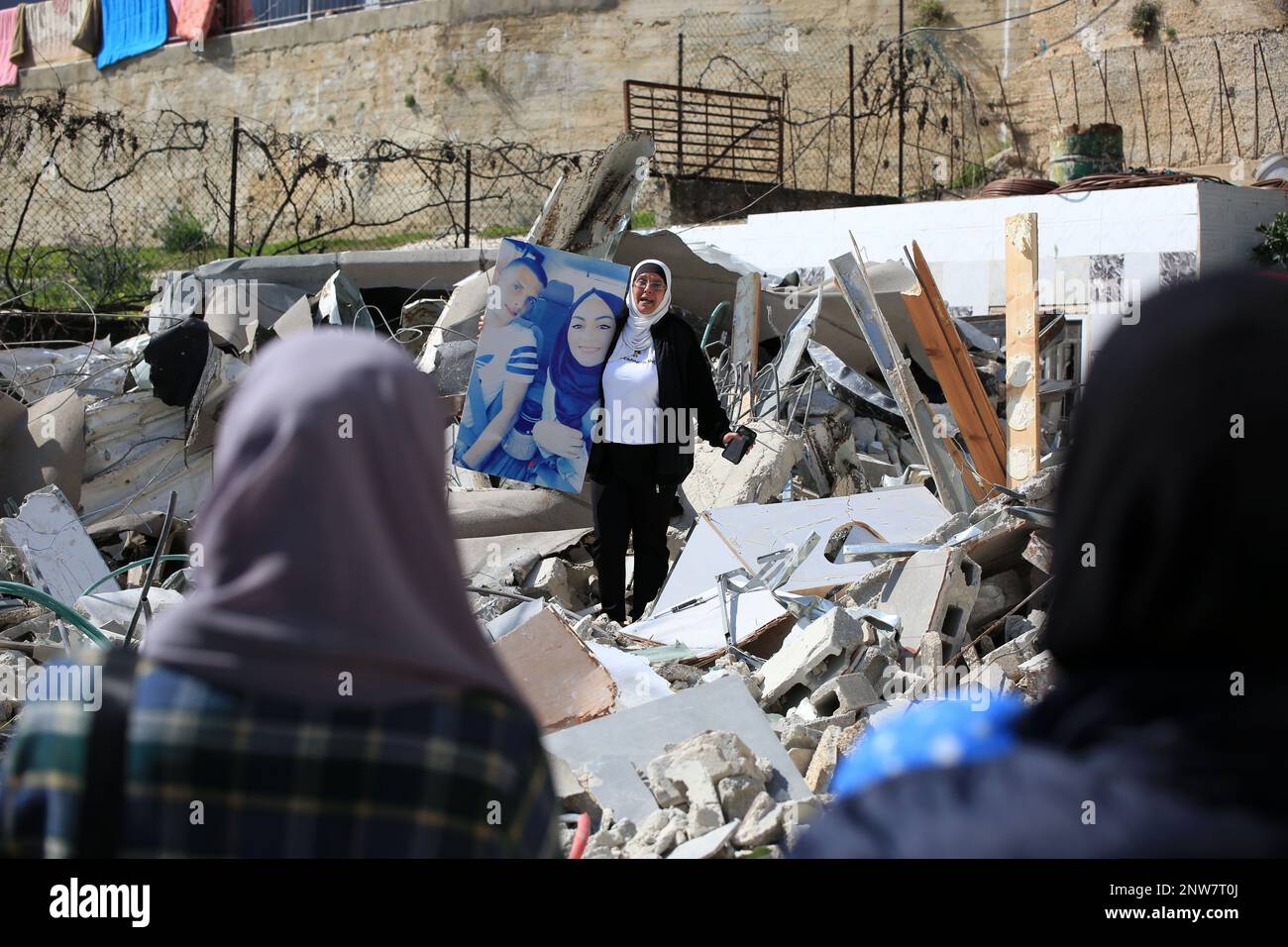 Jerusalem, Israel. 28th Feb, 2023. A woman holds a portrait of relatives after Palestinian Ihab al-Husayni's settlement was demolished by Israel forces for allegedly not having a permit in the Jabal Mukaber neighborhood of East Jerusalem. (Photo by Saeed Qaq/SOPA Images/Sipa USA) Credit: Sipa USA/Alamy Live News Stock Photo