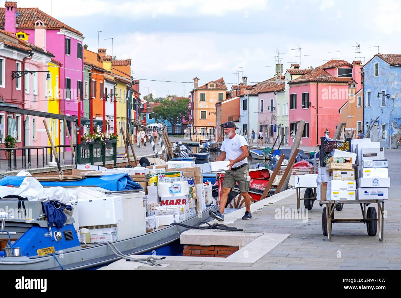 Transport of goods by canal boat and handcarts at car-free Burano, island in the Venetian Lagoon near Venice, Veneto, Northern Italy Stock Photo