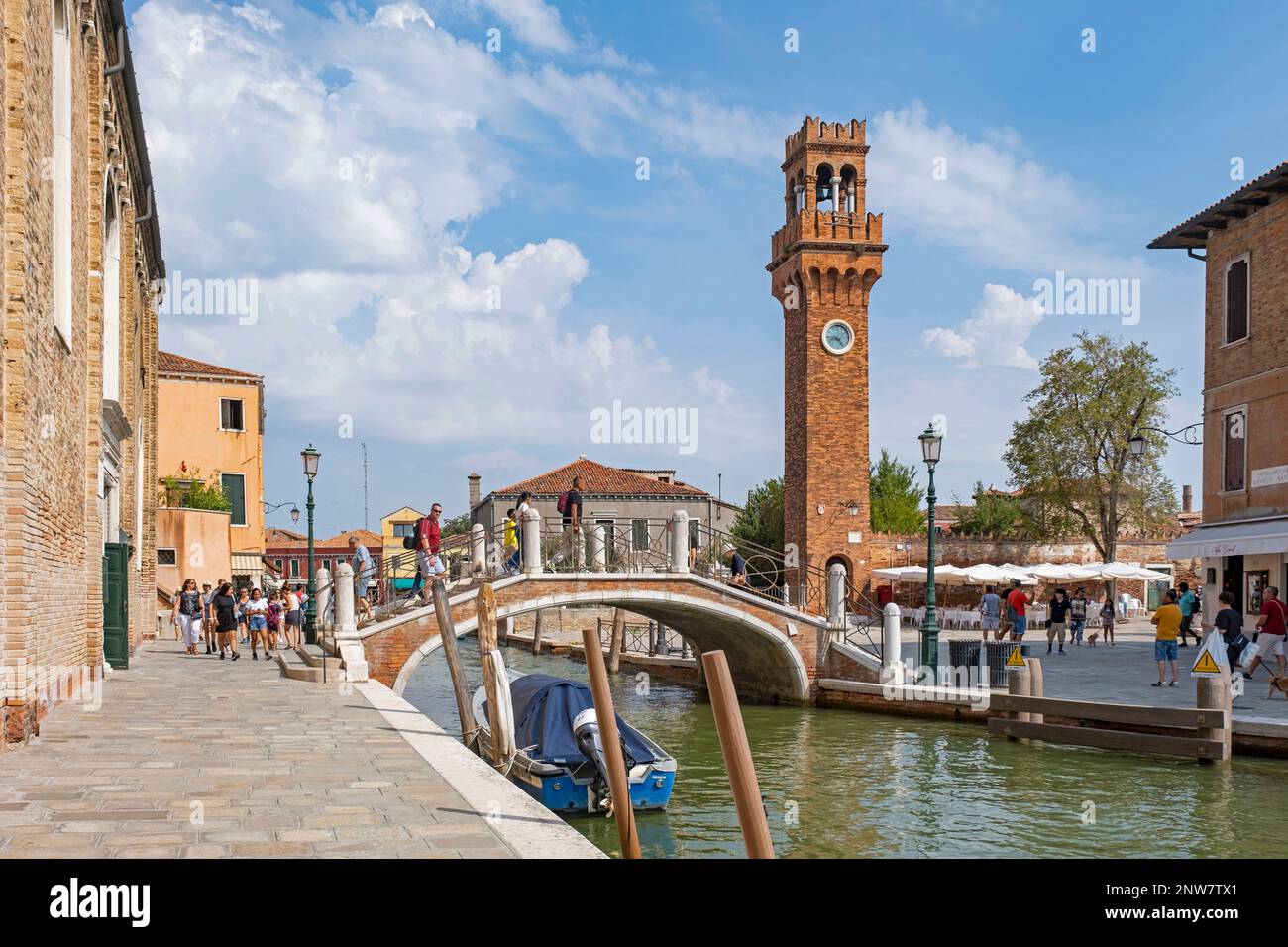 Clock tower and Ponte San Pietro Martire bridge over canal Rio dei Vetrai at Murano, island in the Venetian Lagoon near Venice, Veneto, Northern Italy Stock Photo