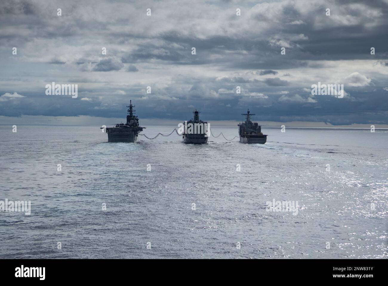 The Military Sealift Command fleet replenishment oiler USNS Laramie (T-AO 203) supplies fuel to the USS Bataan and USS Carter Hall during Amphibious Squadron/Marine Expeditionary Unit Integration Training (PMINT), Jan. 31, 2023. Replenishment at-sea (RAS) is a method of transferring fuel, munitions, and stores from one ship to another while under way. Stock Photo