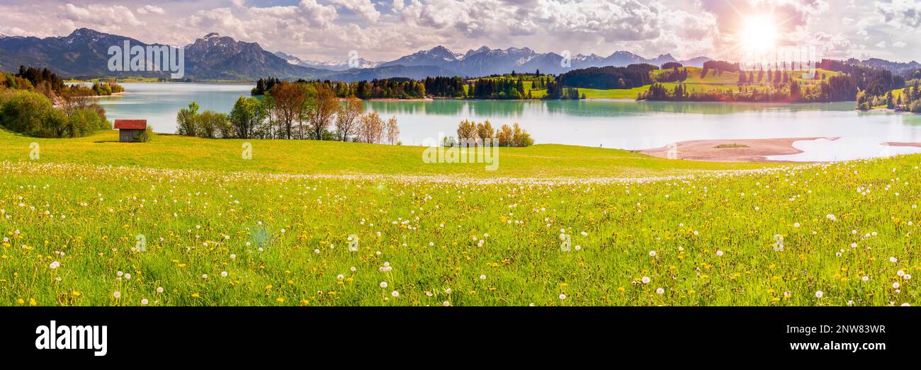 panoramic landscape with lake at springtime in front of mountain range Stock Photo