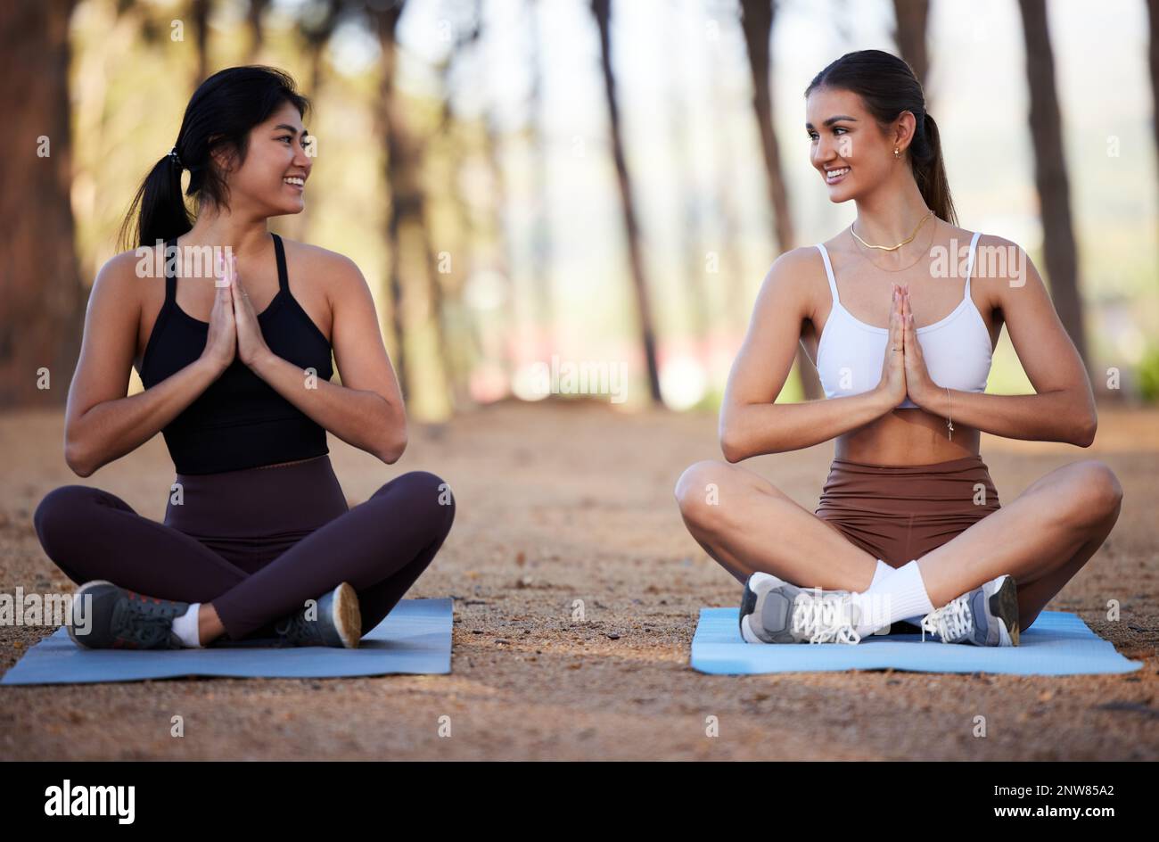 Yoga, outdoor meditation and women exercise in nature for fitness, peace  and wellness. Happy people or friends smile on forest ground for zen workout  Stock Photo - Alamy