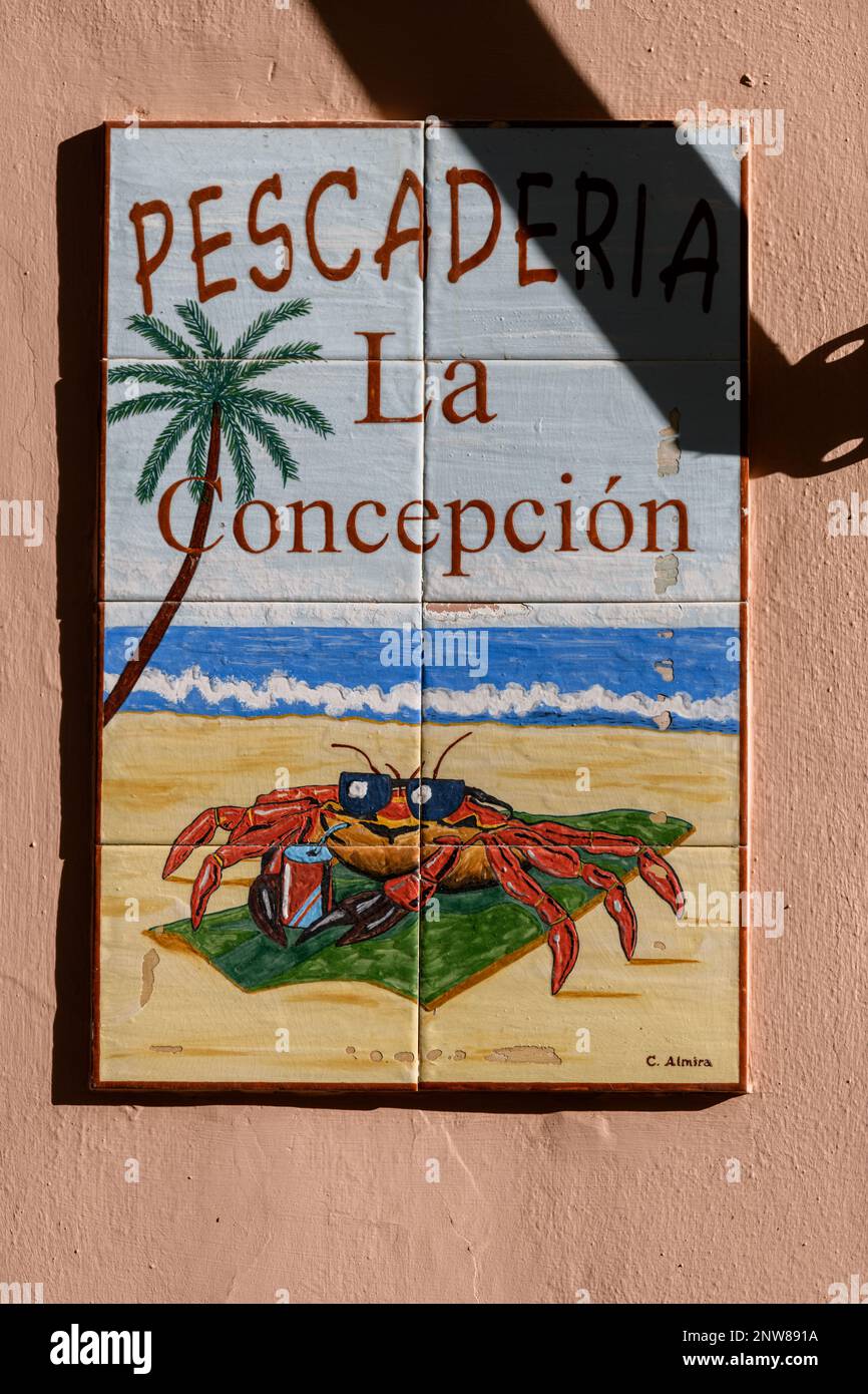 A colourful sunbathing crab in sunglasses on the sign for the Pescaderia La Concepcion seafood market in Calle El Tizon, La Laguna. Stock Photo