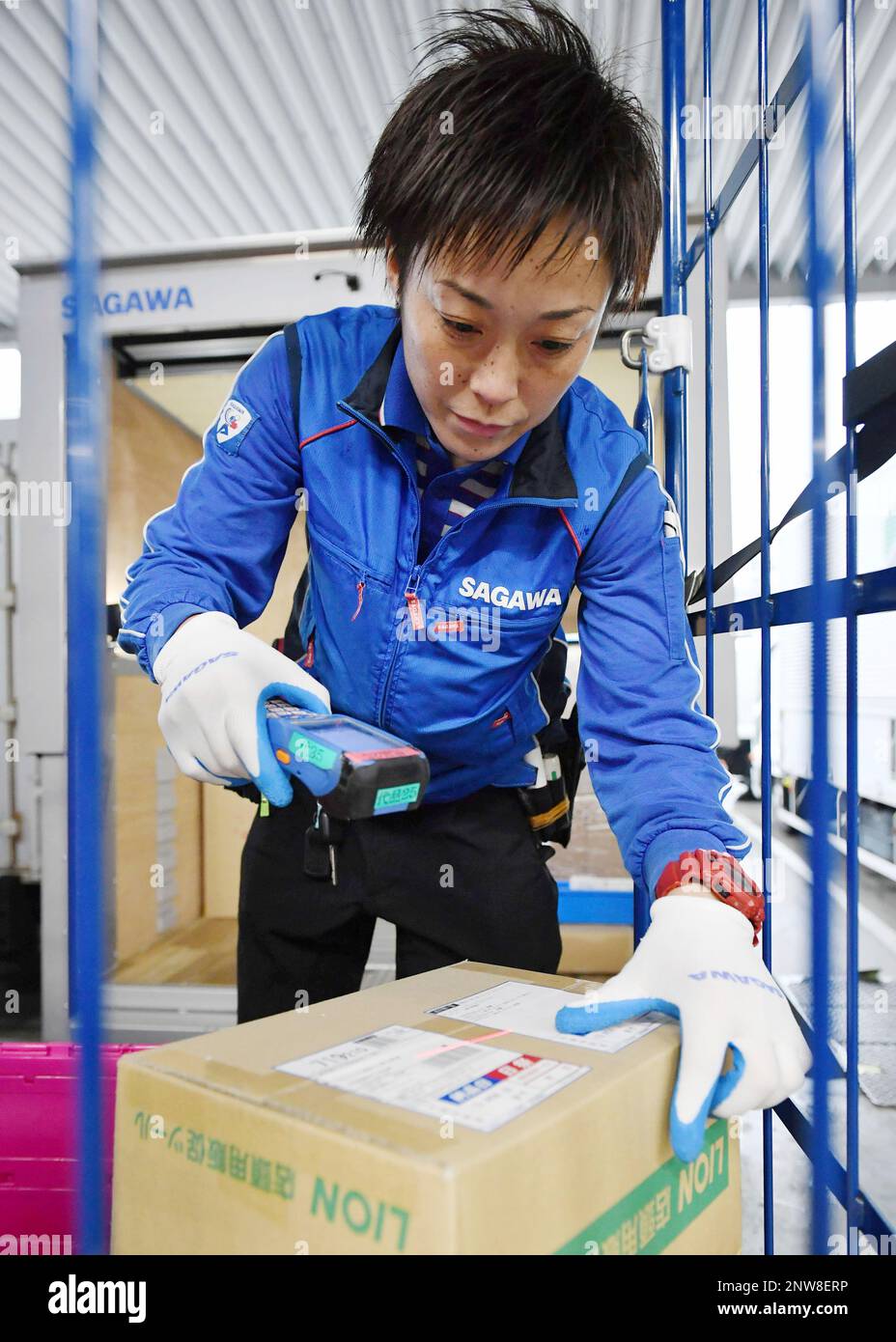 An employee of Sagawa Express works as delivery person in Tokyo on December 6, 2018. ( The