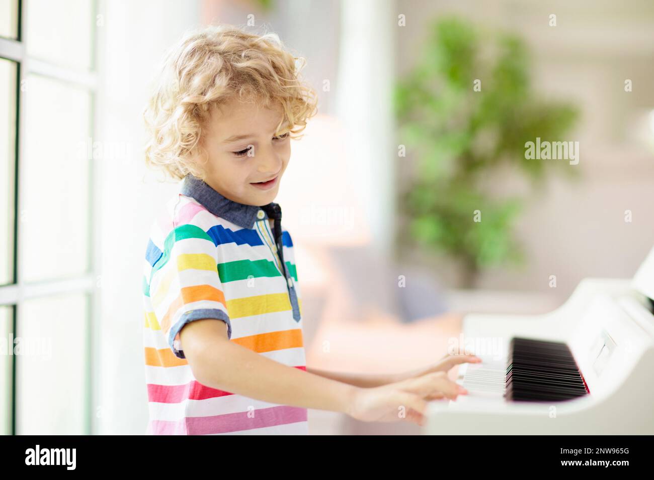 Child playing piano. Kids play music. Classical education for children