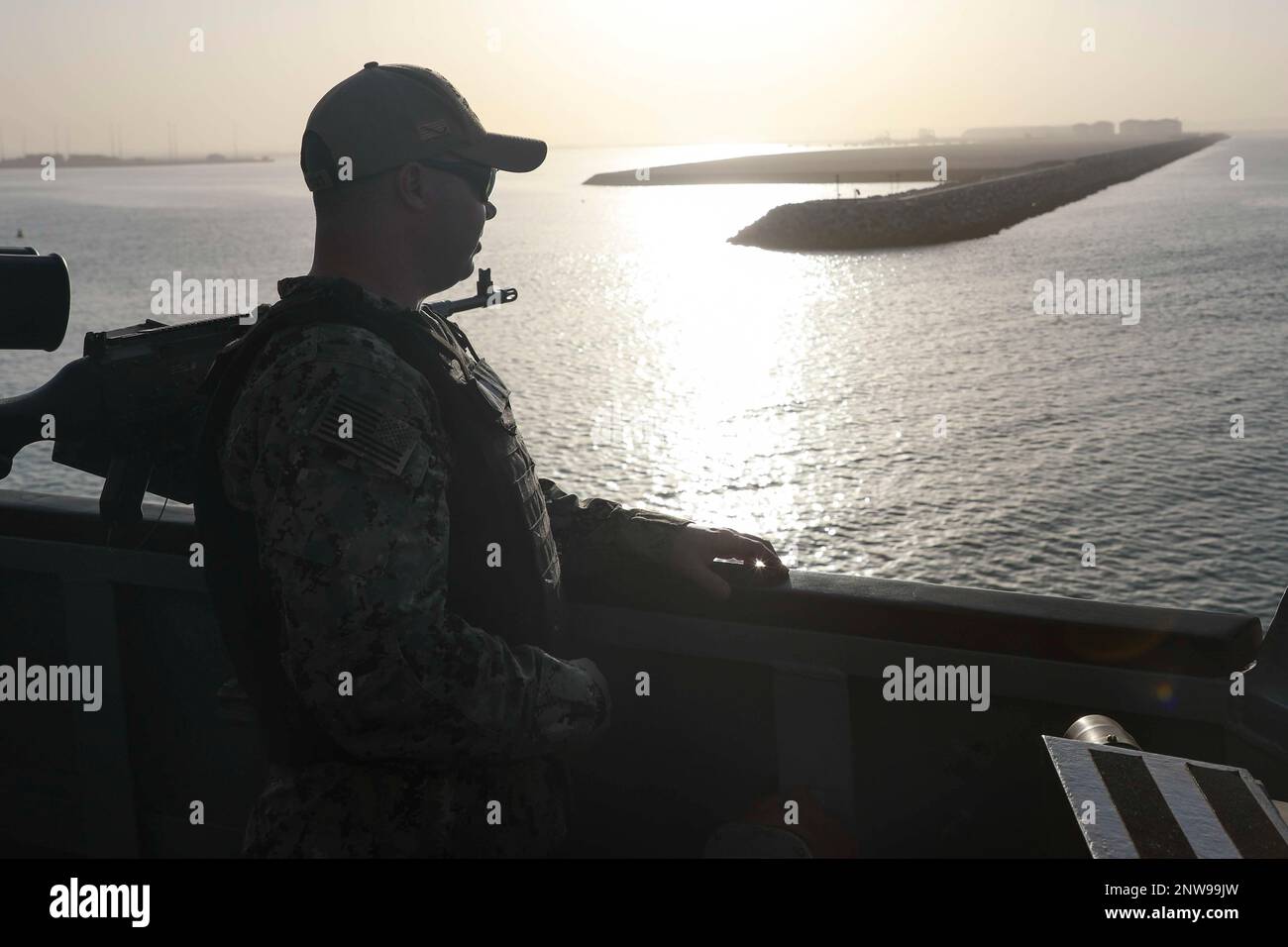 230219-N-JO162-1057 DUQM, Oman (Feb. 19, 2023) Navy Counselor 1st Class Clayton Maxwell, assigned to guided-missile destroyer USS Truxtun (DDG 103), stands watch while departing from Duqm, Oman, Feb. 19, 2023. Truxtun is deployed to the U.S. 5th Fleet area of operations to help ensure maritime security and stability in the Middle East region. Stock Photo