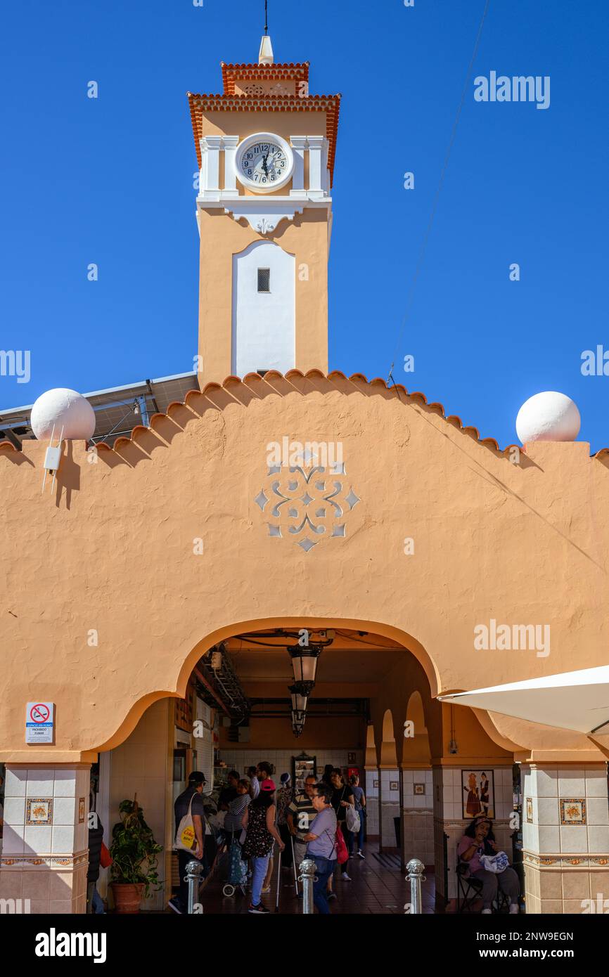 The Moorish-style clock tower rises over the ochre arches and red-tiled roof of the Mercado De Nuestra Senora De Africa in Santa Cruz de Tenerife. Stock Photo