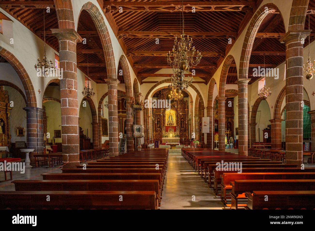 The main nave of the Nuestra Señora de la Concepción church in Santa Cruz with its Mudejar coffered ceiling & Baroque Churrigueresque main altar. Stock Photo