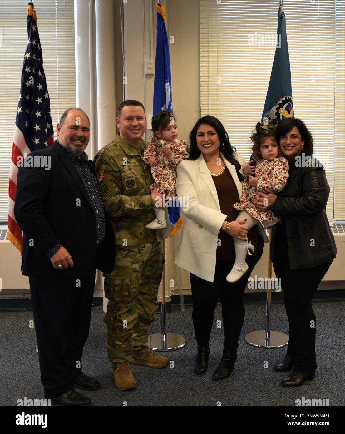 Andrew Munoz, Army Sustainment Command G1 sergeant major, stands with his wife, Natalie Munoz, daughters Zoe, 2, and Isabella, 1, father-in-law Albert Capdevila and mother-in-law Chery Capdevila, during his promotion ceremony to sergeant major on Jan. 9 at Rock Island Arsenal, Illinois. Stock Photo
