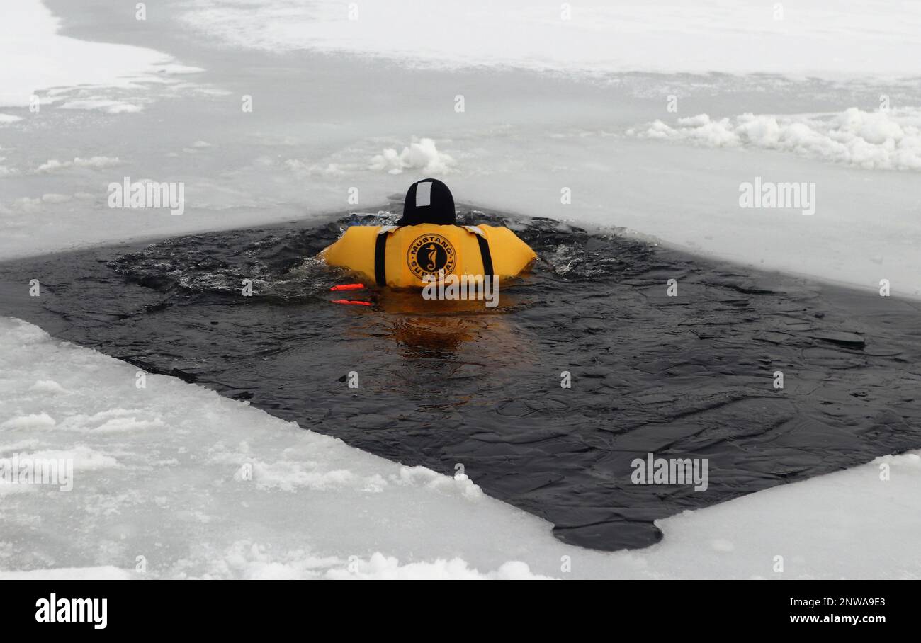 A firefighter wearing a cold-water immersion protective suit acts as a ...