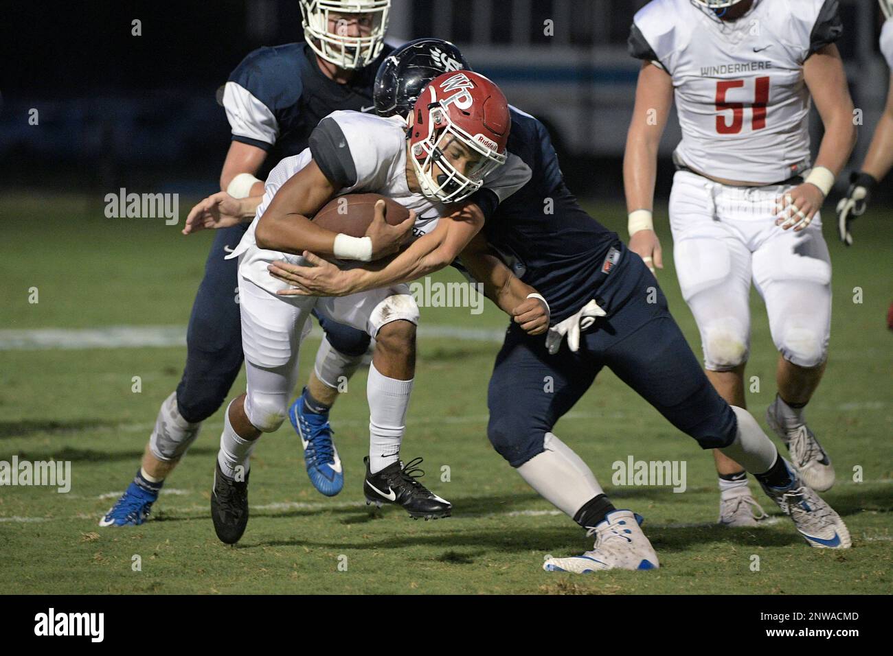 Windermere Prep's Kai Patterson, left, is tackled by Foundation Academy
