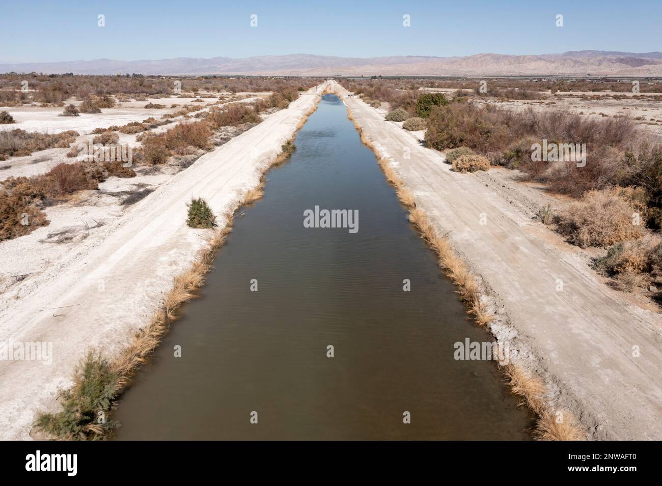 A canal carries fertilizer-laden agricultural runoff from farms in the Coachella Valley to the Salton Sea, a dying lake in southeastern California. Stock Photo