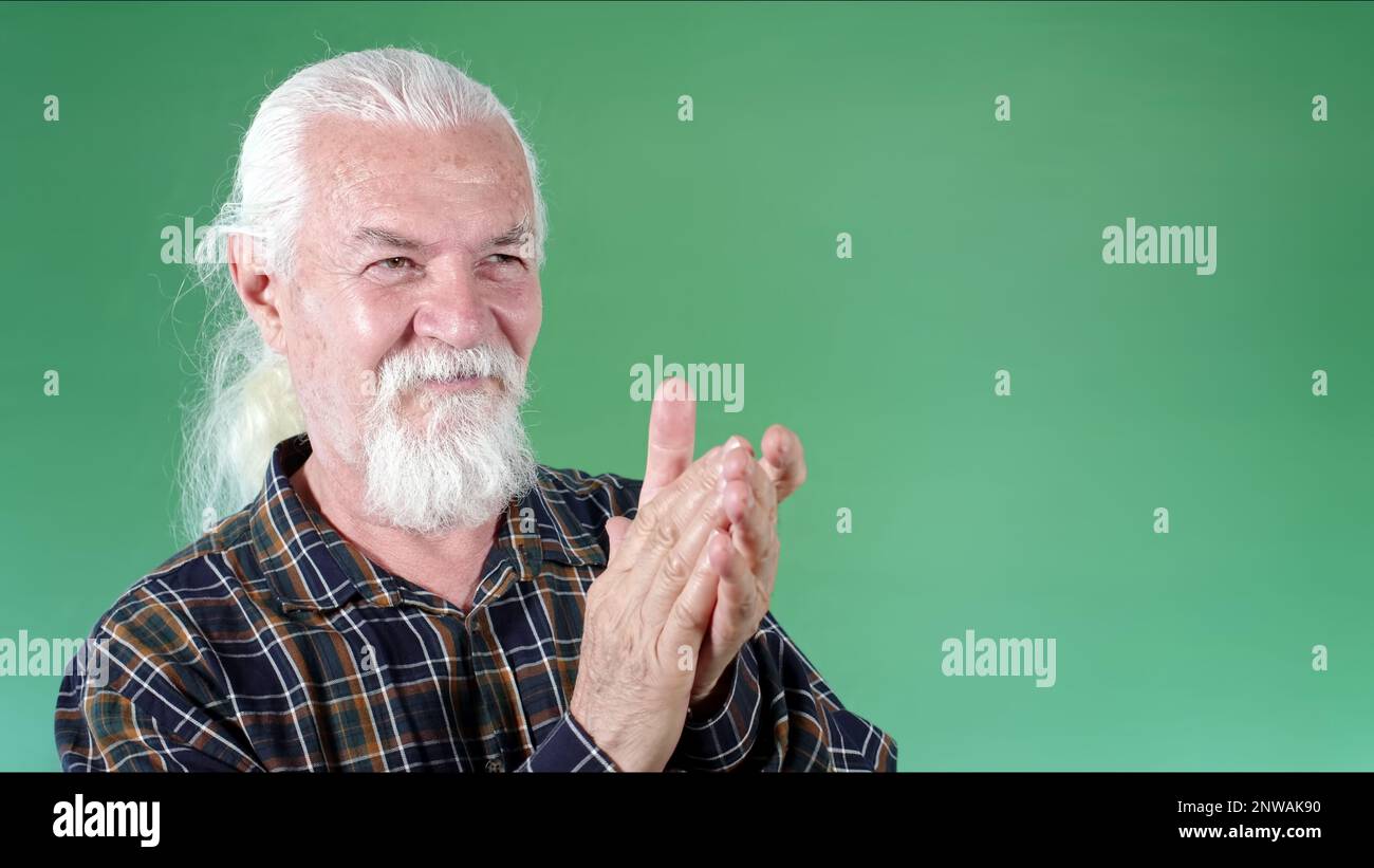 The Old man is Clappping His Hands Photo Stock Photo