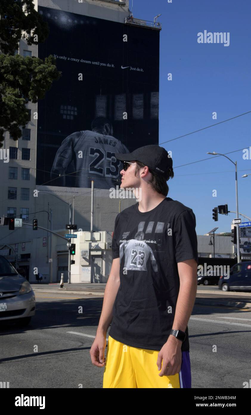 Dylan Stewart of Riverside, Calif. poses in front of Nike ad featuring Los  Angeles Lakers forward LeBron James to commemorate the 30th anniversary of  the "Just Do It" campaign on the side