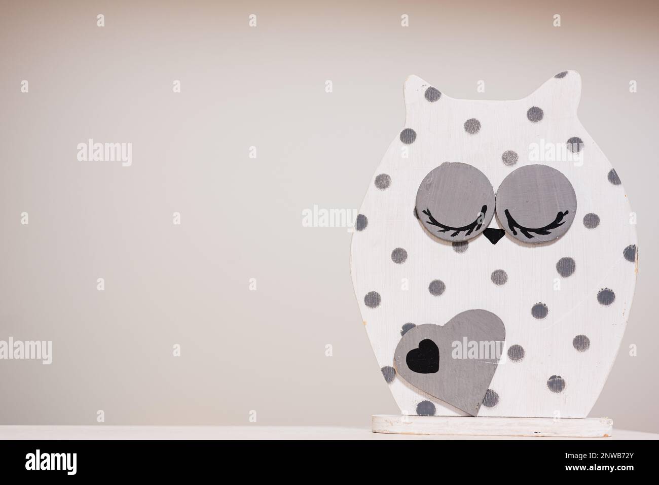 White and gray dot wooden owl figurine isolated Stock Photo - Alamy