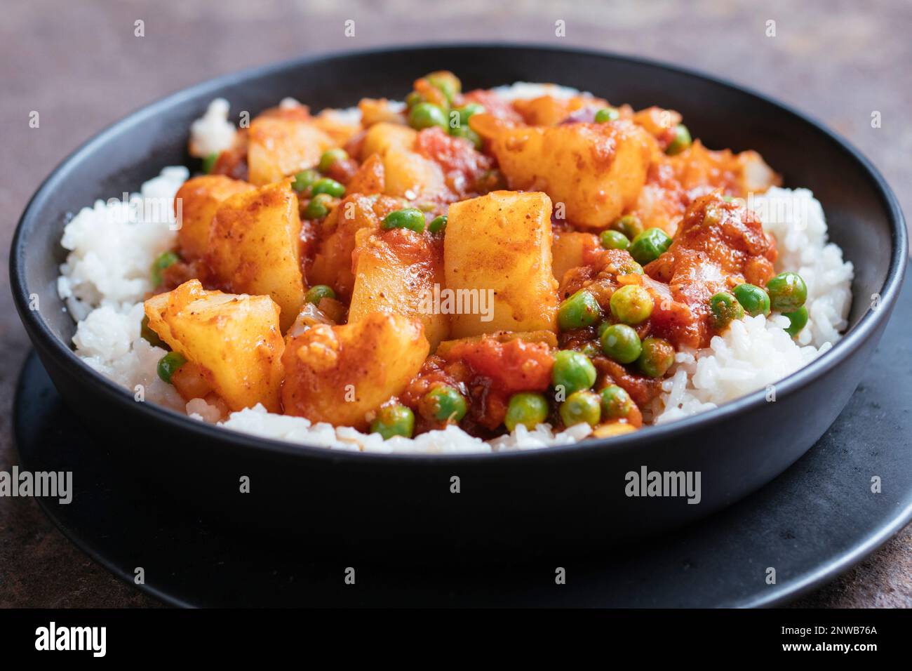 Potato and Pea Curry on Rice Stock Photo
