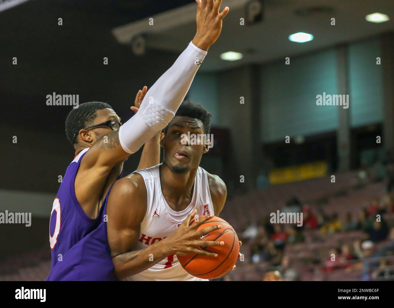 HOUSTON, TX - NOVEMBER 19: Northwestern State Demons center Ishmael Lane  (20) tries to block a shot by Houston Cougars center Chris Harris Jr. (1)  during the Men's basketball game between the