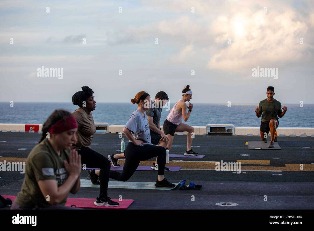 230218 N YG415 1271 LT. Jarred Reid Dixon instructs a high intensity interval training HIIT class during a morale day on the flight deck of amphibious assault ship USS Makin Island LHD 8 Feb. 19 2023 ...