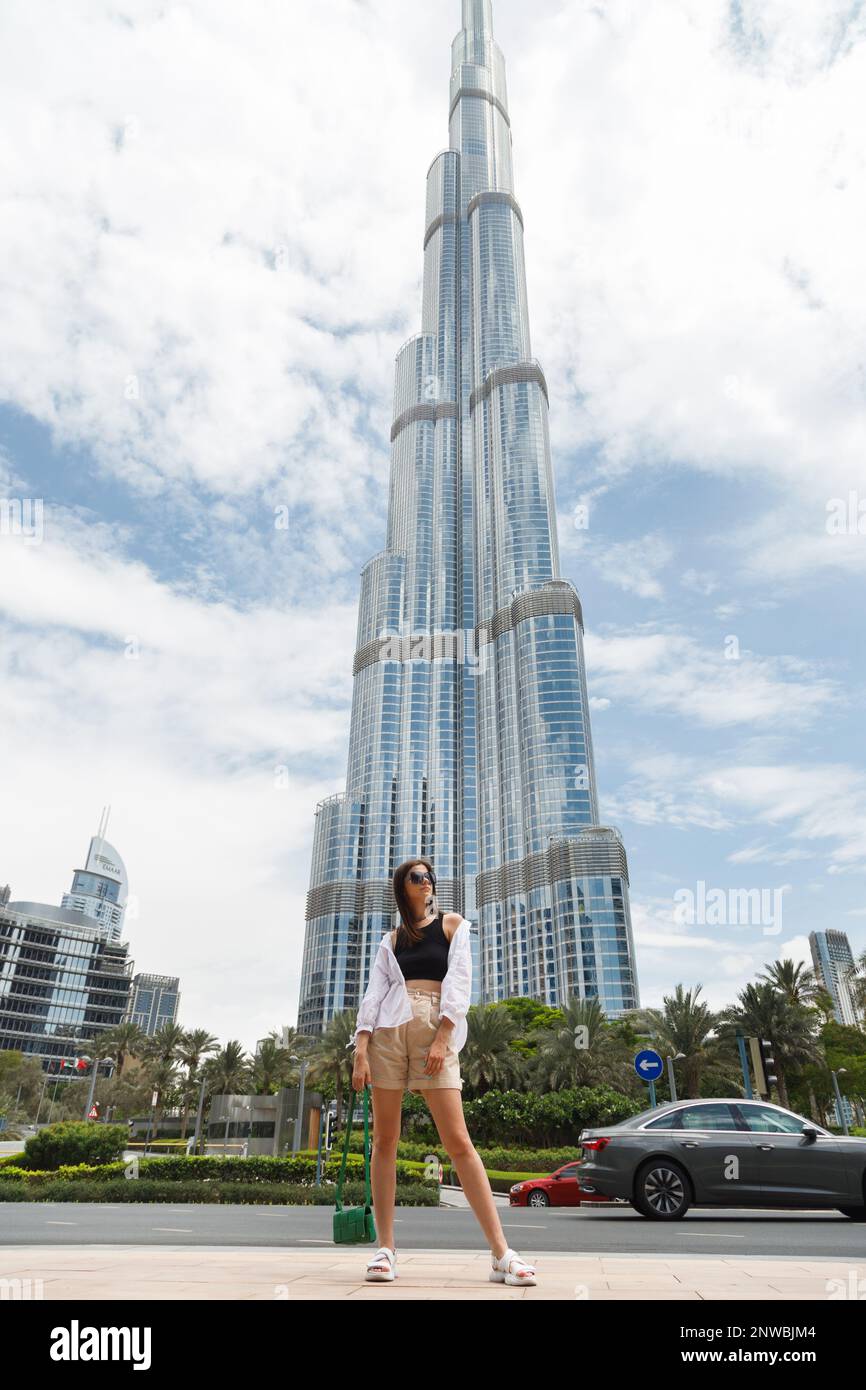 DUBAI, UAE . A happy young woman enjoys the view in front of the Burj  Khalifa Stock Photo - Alamy