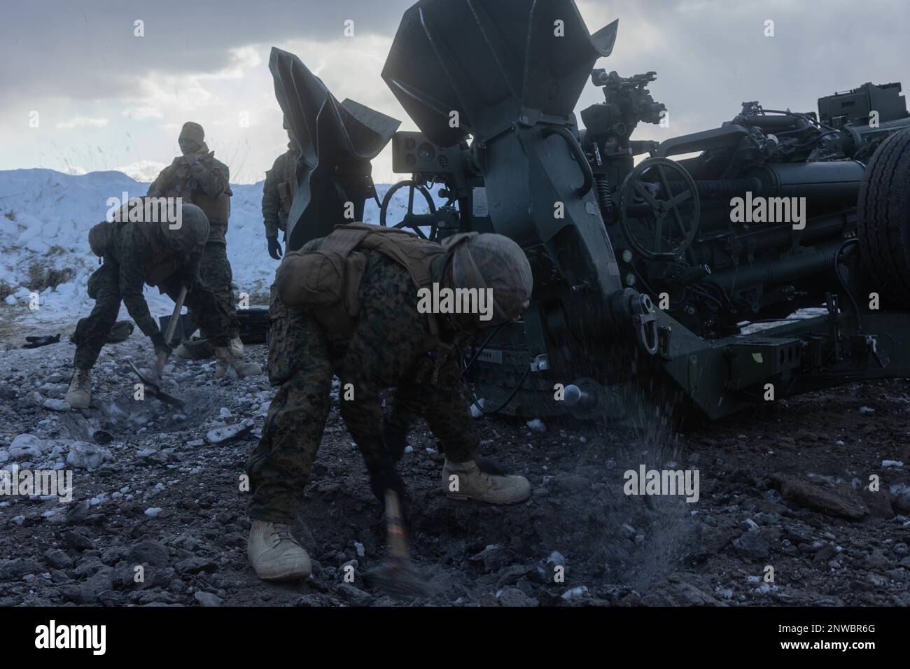 U.S. Marines with 3d Battalion, 12th Marines emplace an M777 towed 155 mm howitzer while conducting live-fire training during Artillery Relocation Training Program 22.4 at the Yausubetsu Maneuver Area, Hokkaido, Japan, Jan. 31, 2023. The skills developed at ARTP increase the proficiency and readiness of the only permanently forward-deployed artillery unit in the Marine Corps, enabling them to provide precision indirect fires. Stock Photo