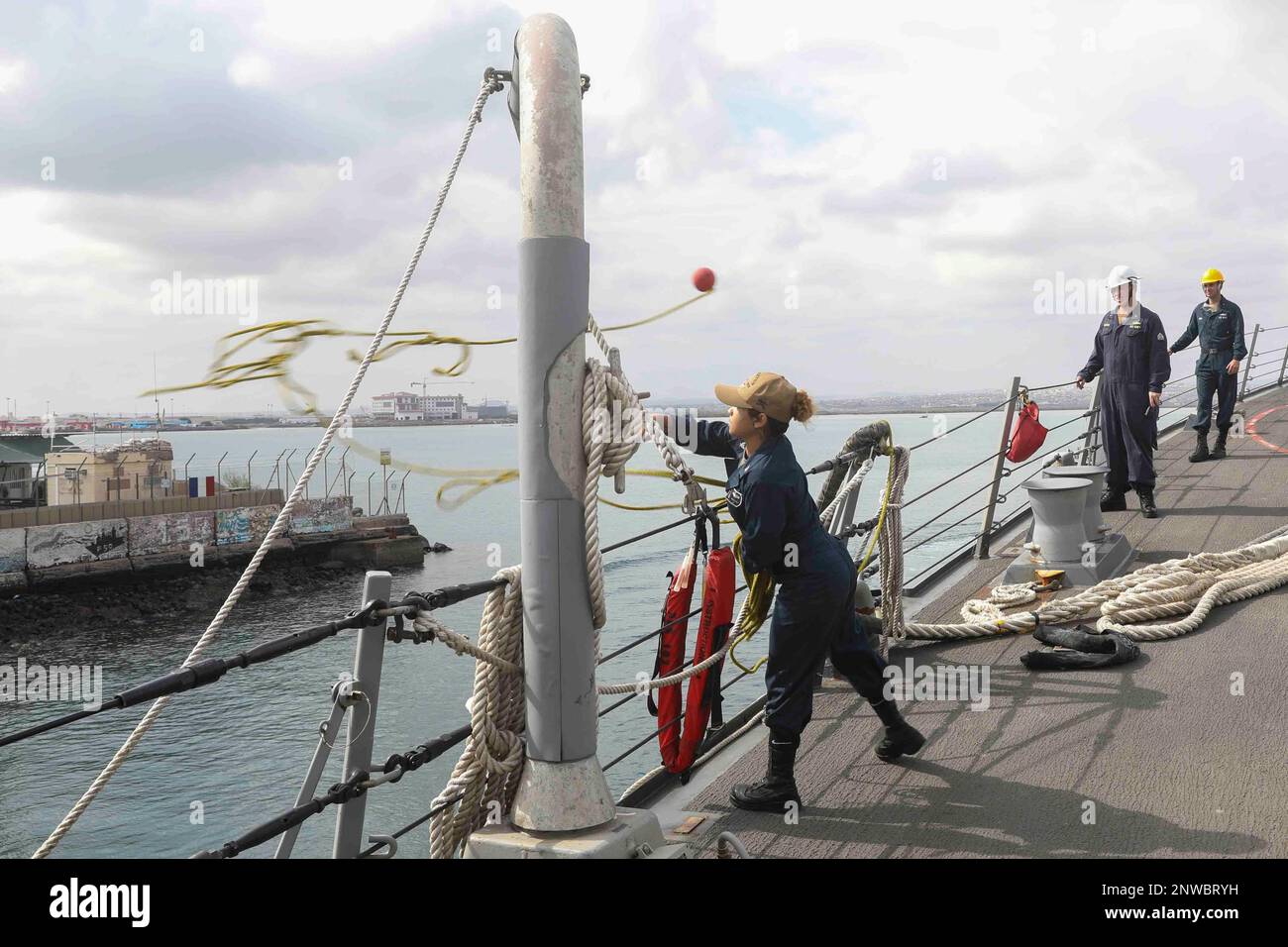 230204-N-JO162-1016 DJIBOUTI (Feb. 4, 2023) Retail Specialist 3rd Class Windy Martelo casts a line from the guided-missile destroyer USS Truxtun (DDG 103) in Djibouti, Feb. 4, 2023. Truxtun is deployed to the U.S. 5th Fleet area of operations to help ensure maritime security and stability in the Middle East region. Stock Photo