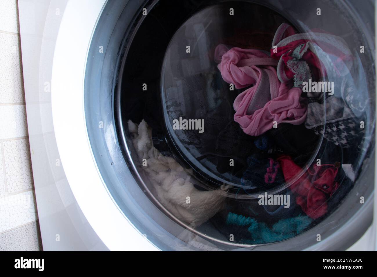 dirty old washing machine with things, washing clothes in a washing