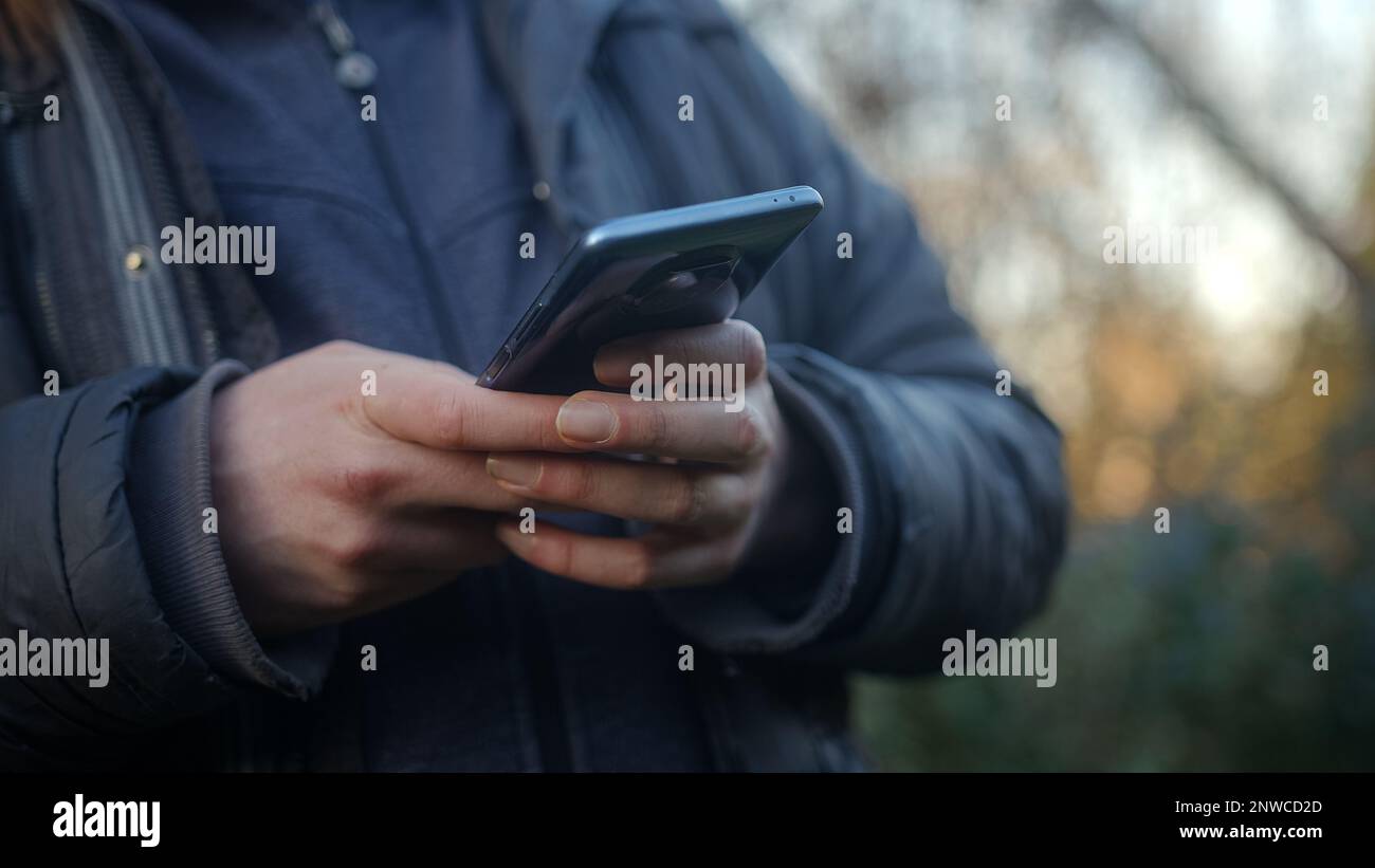 Close-up of Hands Using Smartphone and App Stock Photo