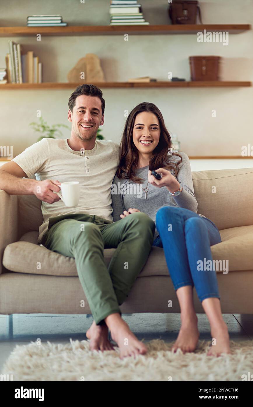 Movie date on the home front. Portrait of a happy young couple relaxing ...
